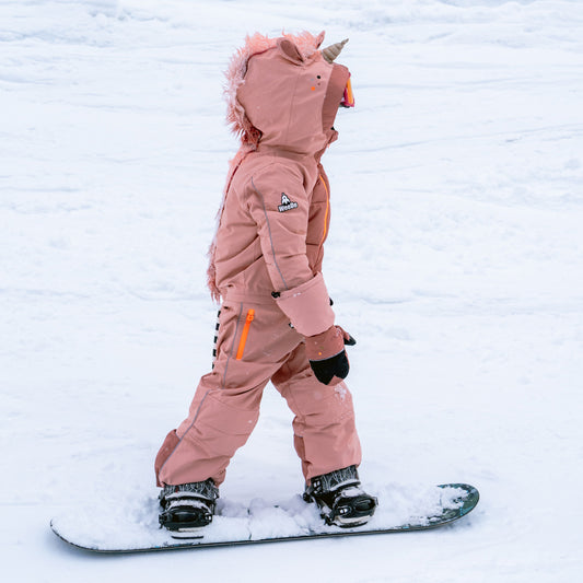 Child snowboarding in the UNIDO Glitter Snowsuit
