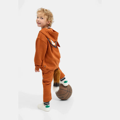 Child in the FOXDO Sweatsuit walking away with a ball, showing the relaxed fit of the hoodie and joggers.