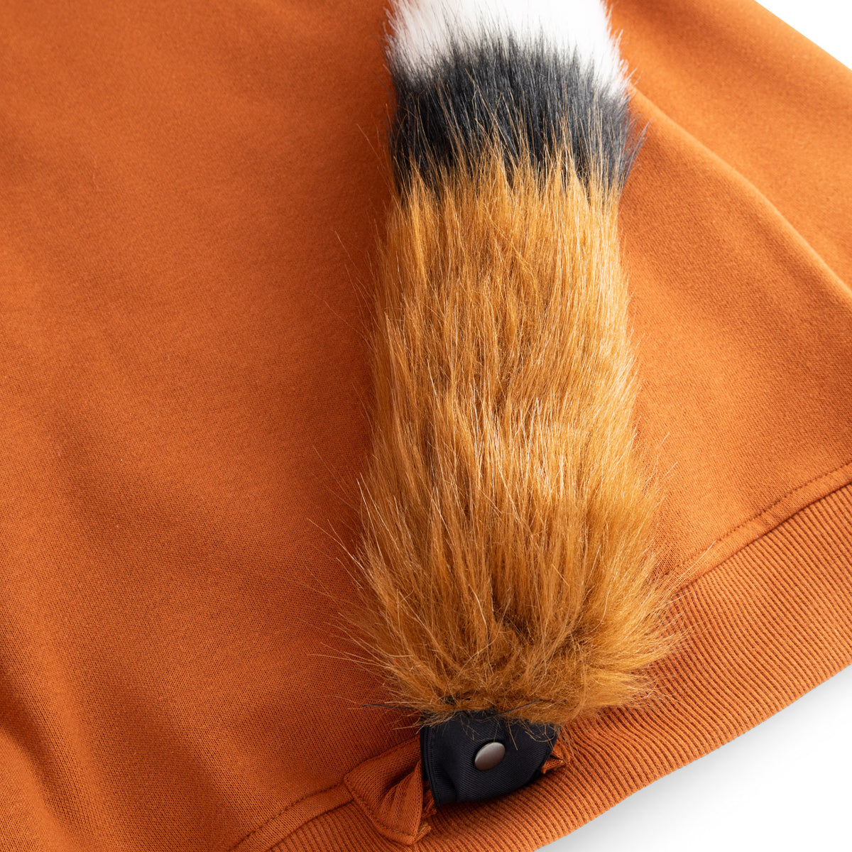 Close-up of the detachable fox tail snapped onto the back of the FOXDO joggers.