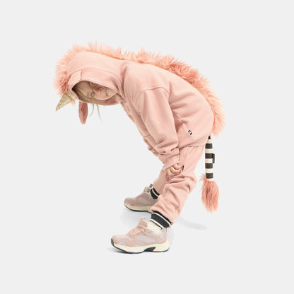 Child bent forward in the UNIDO Sweatsuit with the faux-fur unicorn mane hanging from the hood.