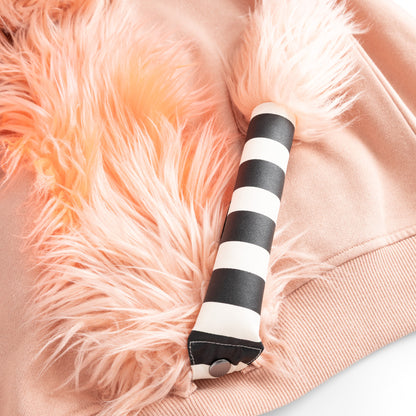 Close-up of the detachable blush faux-fur unicorn tail on the back of the UNIDO joggers.