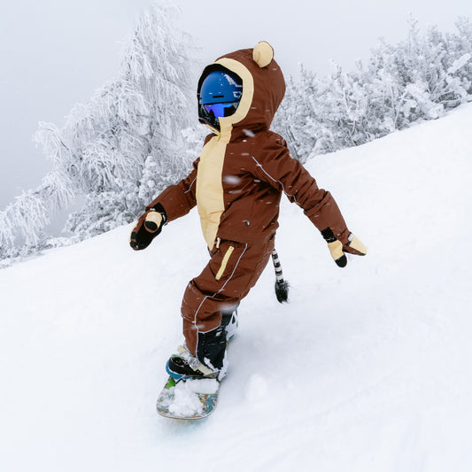 Child snowboarding in the MONKEYDO Snowsuit