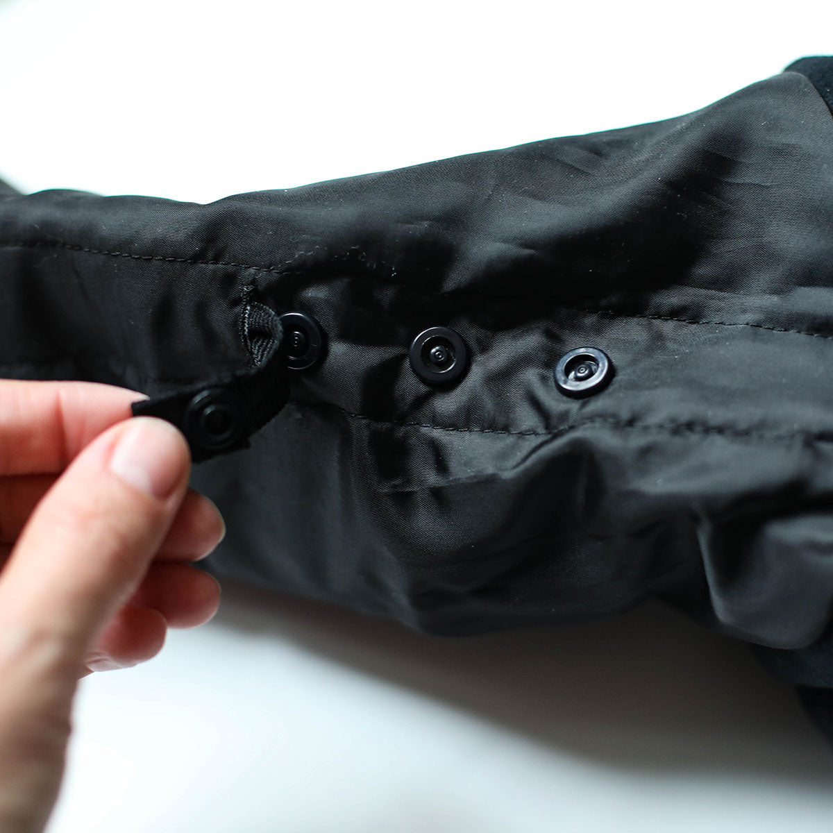 Internal snaps releasing extra length in a WeeDo snowsuit sleeve